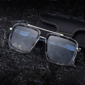Retro double-bridge polarized sunglasses with square metal frame on dark stone background
