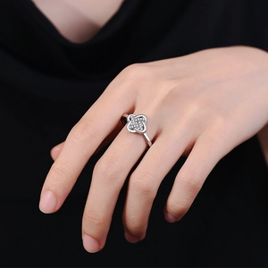 Adjustable silver four-leaf clover ring with pavé zircon crystals on hand model