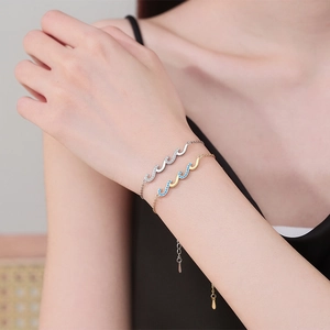 Elegant wavy diamond-encrusted bracelets in silver and gold tones for women