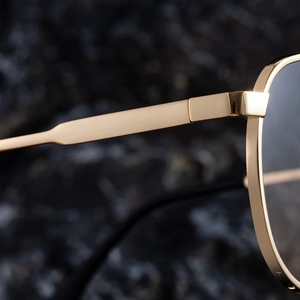 Macro shot of durable golden metal hinge and frame detail of aviator sunglasses