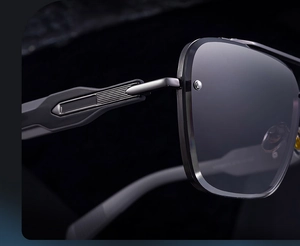 Macro detail of gunmetal hinge and textured metal structure on square frame sunglasses