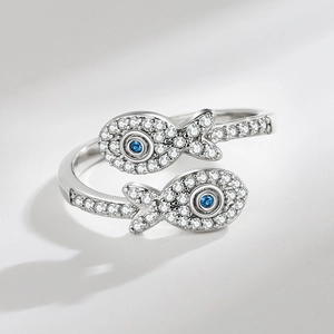 Minimalist silver open fish ring with white cubic zirconia and blue stone eyes