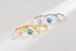 Detailed top view of gold and silver enamel rings with colorful round moissanite stones