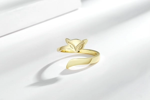 Macro detail of polished gold fox open ring featuring minimalist geometric animal design