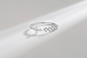 Macro detail of silver cross ring featuring shimmering micro-pave cubic zirconia accents