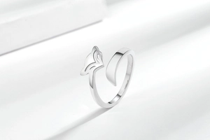 Macro shot of minimalist silver fox open ring showing the sleek metallic head and tail