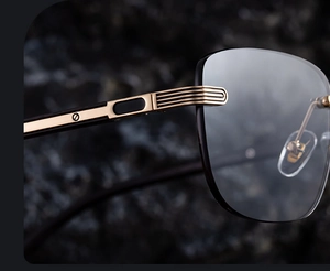 Macro shot of gold metal hinges and screw details on luxury rimless men's sunglasses