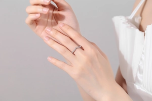 Detail of elegant V-shaped micro-pave moissanite silver ring worn by a model