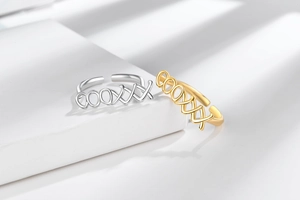Close-up of gold and silver adjustable open rings with hollow cross geometric patterns