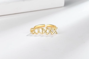 Macro shot of minimalist gold hollowed LOVE letter pattern on open adjustable ring