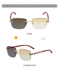 Detail of rimless photochromic sunglasses with wood grain temples and gold metal bridge