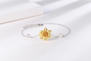 Detail of sunflower bracelet with gold petals, yellow crystals, and white pearls on chain