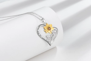 Close-up of heart pendant with gold sunflower and You are my sunshine engraving