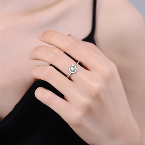 Minimalist enamel round moissanite ring in bezel setting worn by model for daily style