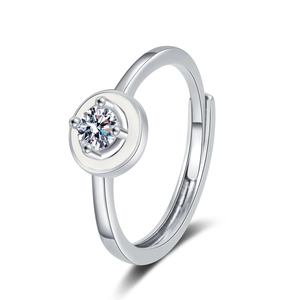 Adjustable silver ring with round moissanite and white enamel on a white background