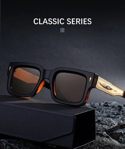 Detailed macro view of square sunglasses with vintage gold embossed temples and gems