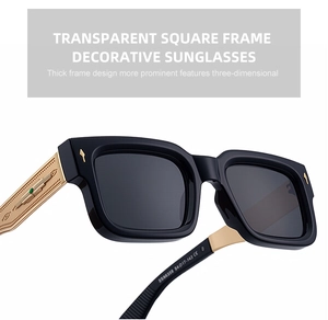 Detail of square sunglasses featuring thick black frames and engraved gold metal temples