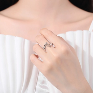 Bague réglable argentée avec motif LOVE et cœur portée sur la main d'un mannequin