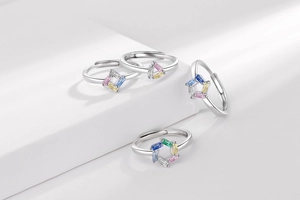 Macro detail of geometric open rings featuring colorful baguette-cut zircon gemstones