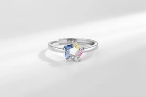 Macro shot of an adjustable silver ring featuring five colorful rectangular zircons