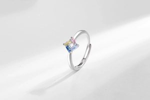 Macro detail of adjustable silver ring with four-claw set colorful rectangular zircons