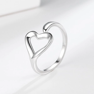 Minimalist silver heart open ring with adjustable band on elegant beige background