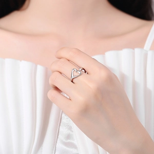 Elegant silver open heart ring with minimalist adjustable design on model hand