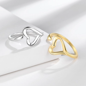 Minimalist open heart rings in gold and silver finish on white geometric display