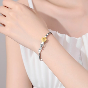 Daisy sunflower open bracelet with You are my sunshine engraving shown on a female wrist