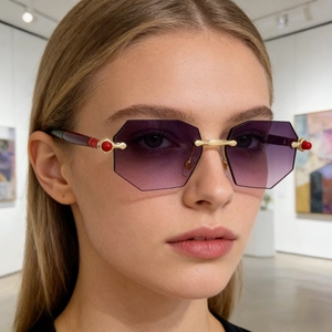 Close-up of rimless polygon sunglasses with purple gradient lenses and gold accents