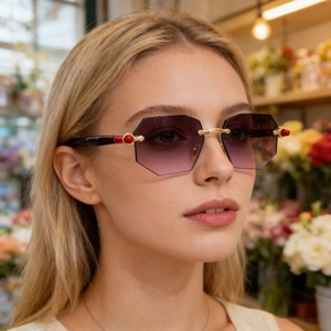 Detail of rimless polygon sunglasses with purple gradient lenses and gold metal frames