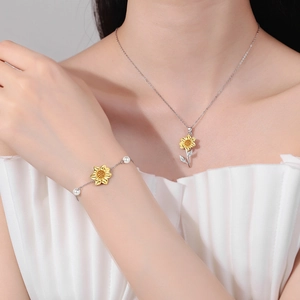 Elegant sunflower jewelry set with necklace and pearl bracelet on model neck and wrist