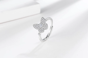 Detailed close-up of butterfly ring featuring zircon pavé and adjustable silver band