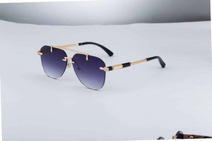 Detailed close-up of engraved gold metal temples on rimless gradient purple sunglasses