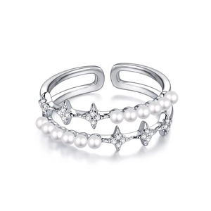 Detail showing double-layered silver ring with white pearls and zircon star charms