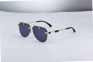 Detailed macro view of gold metal temples with exquisite textures on rimless sunglasses