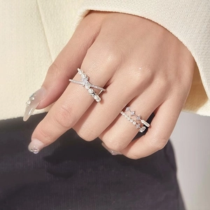 Detailed view of double-layer silver rings with pearls and sparkling cubic zirconia