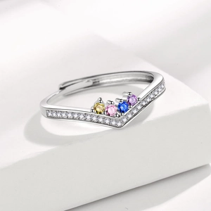 Rainbow crown ring in silver with colorful gemstones and pavé stones on a white stand