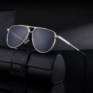 Classic aviator sunglasses with matte titanium frame and leather case on mirror surface