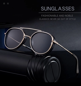 Close-up of retro punk double-bridge sunglasses with black lenses and gold metal frame