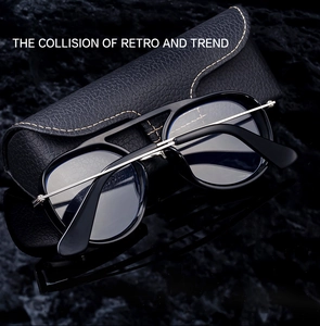 Close-up of retro black round frame sunglasses with silver temples and leather case