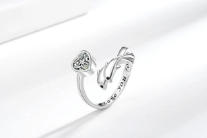 Close-up of adjustable whale ring with heart zircon and 'Love you for' engraving