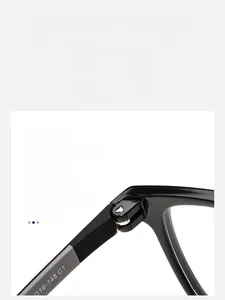 Detailed macro view of the reinforced metal hinge and model code on black square glasses