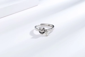 Macro shot of silver fortune cat ring with coin charm and adjustable open band