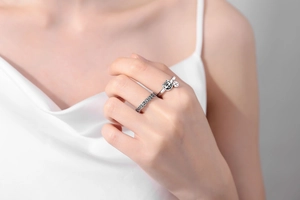 Close-up of Lucky Cat open ring and ancient coin band on model hand with silver finish