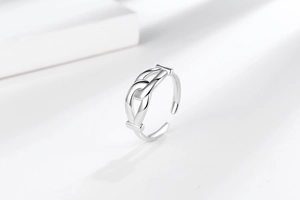 Close-up of silver knot ring with polished double-loop design and adjustable opening