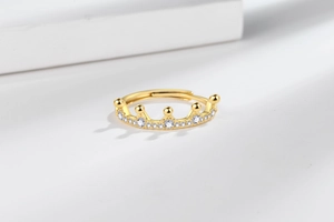 Detail of 18K gold crown ring showing intricate pavé zircon settings and adjustable open band