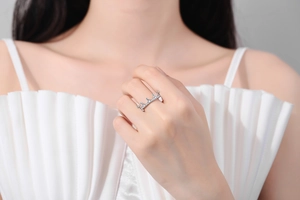 Close-up of crown shaped silver ring with sparkling cubic zirconia on model's finger