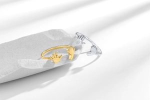 Detailed macro view of adjustable twisted rope rings with cute handprint and footprint motifs