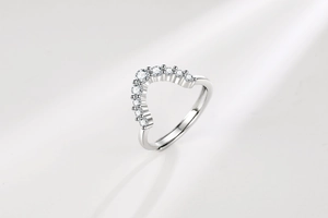 Detailed macro view of V-shaped ring with nine sparkling round zircons on silver band